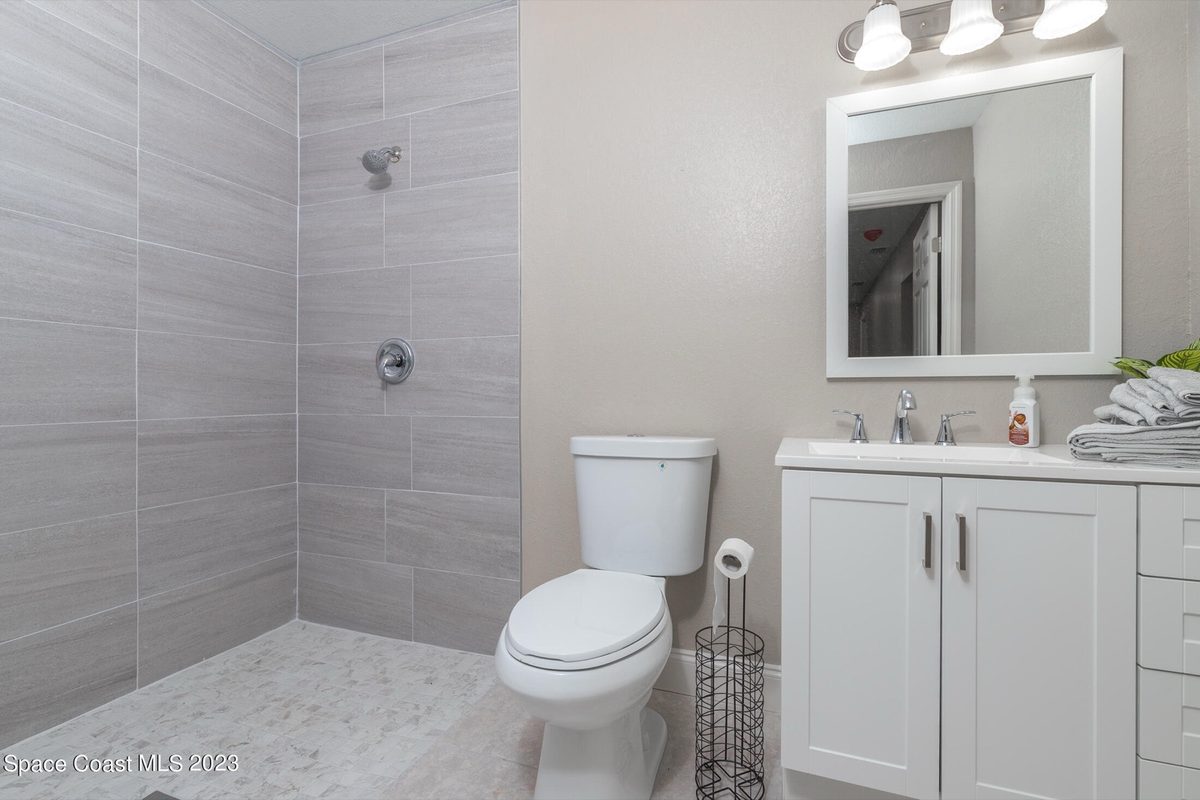 After: fresh gray tile, new vanity, modern fixtures