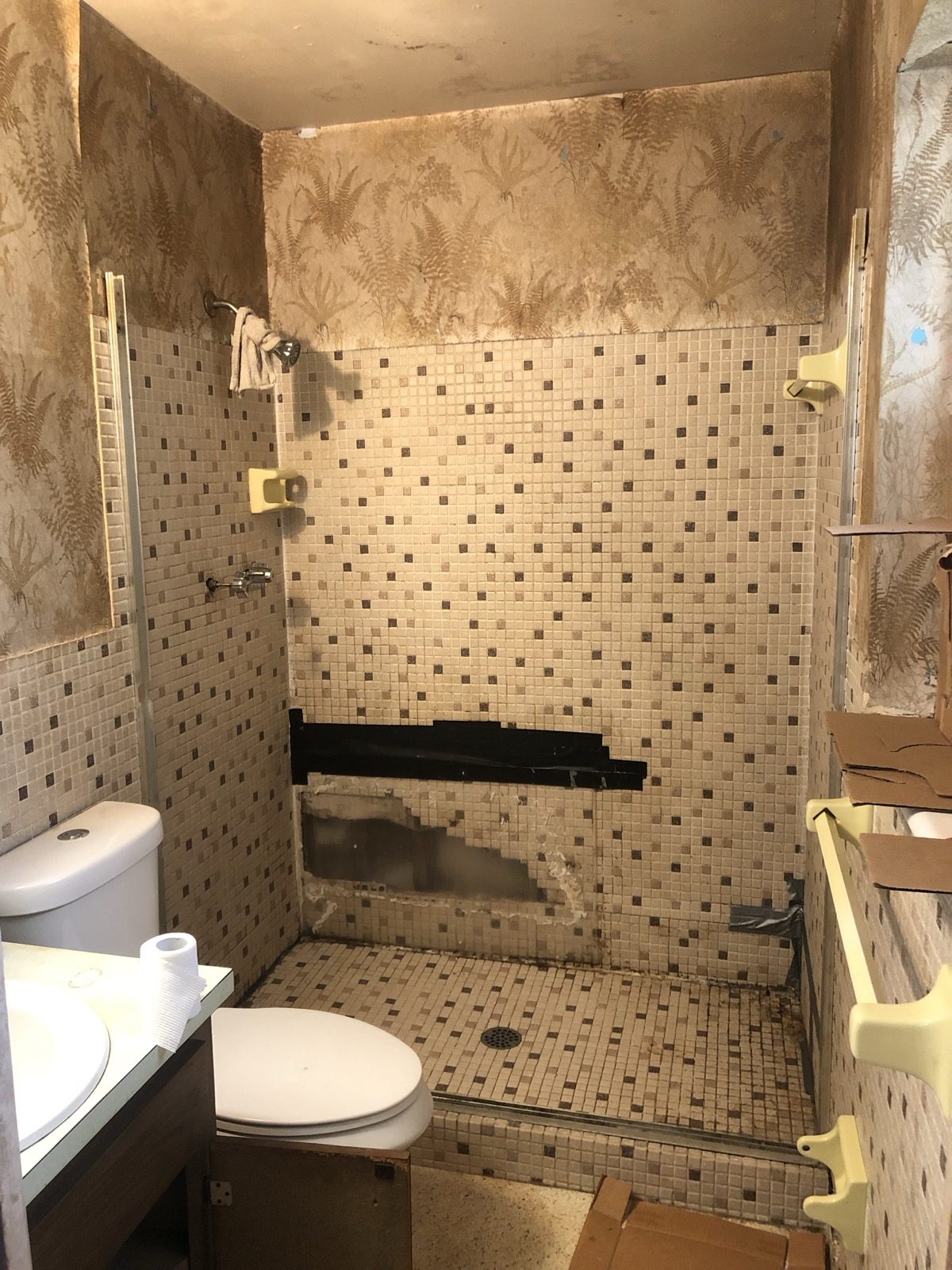 Before: dated tile, worn fixtures, peeling paper