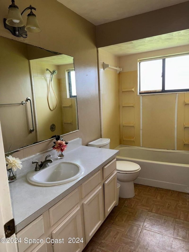 Tackett family bathroom before: dated tile and fixtures