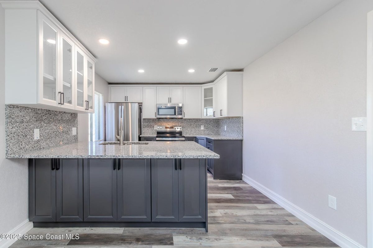 After: bright white cabinets, new counters, clean finishes