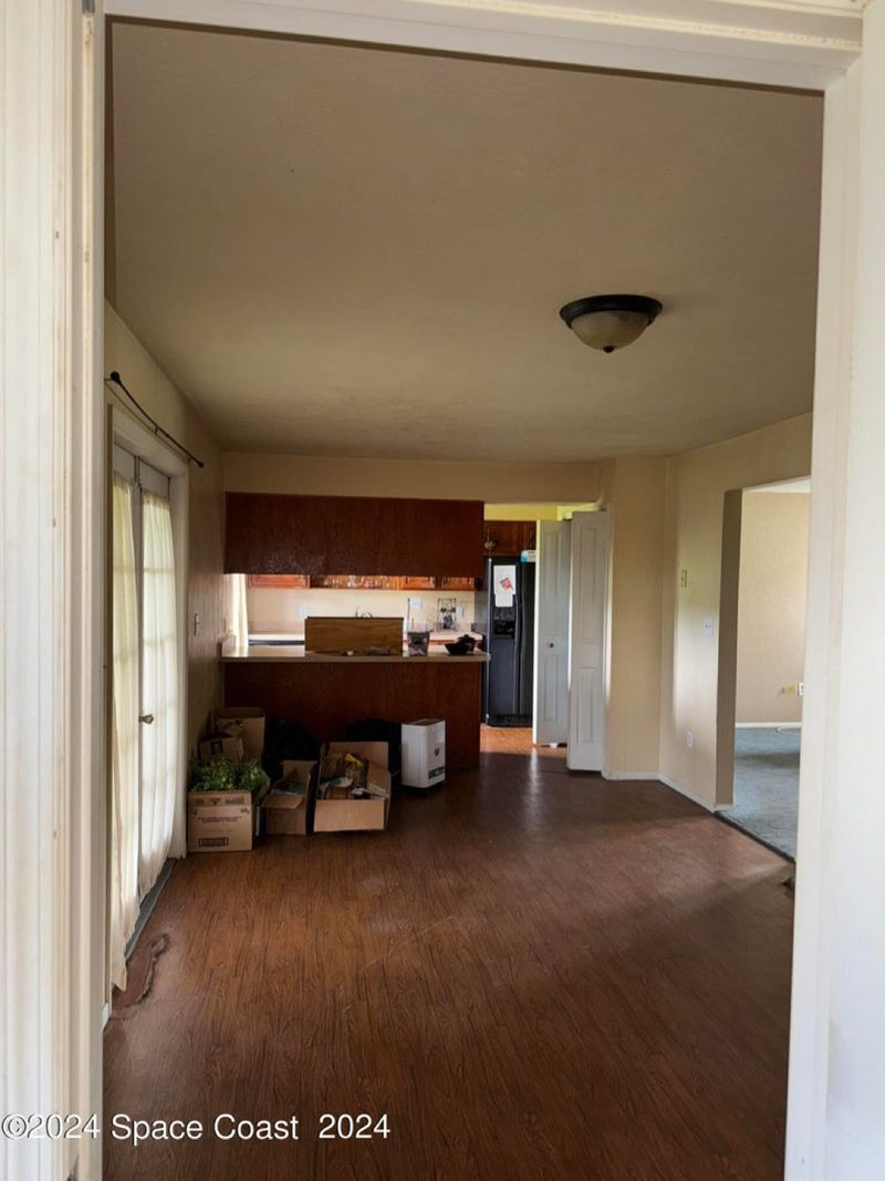 Before: dated cabinets, worn flooring, old appliances