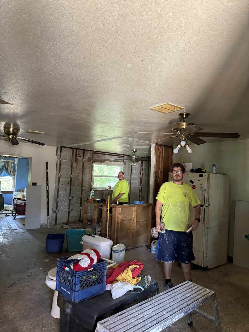 Crew clearing out a gutted room